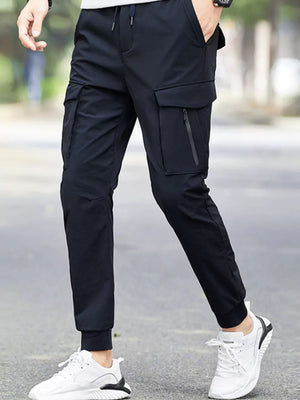 Black cargo joggers with drawstring waist and zippered pockets, cuffed ankles.