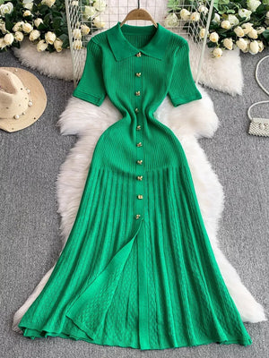 Green ribbed knit midi dress with collar, short sleeves, and gold button detail.