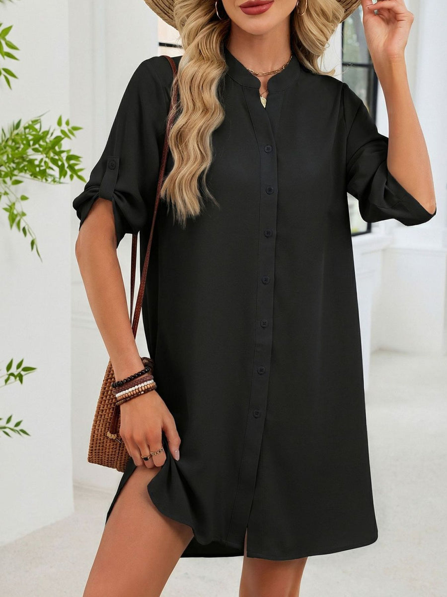 Black button-down shirt dress with band collar and roll-tab sleeves.