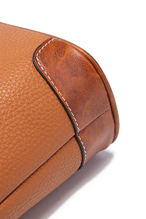 Leather crossbody bag in tan with contrast stitching and brown trim detail