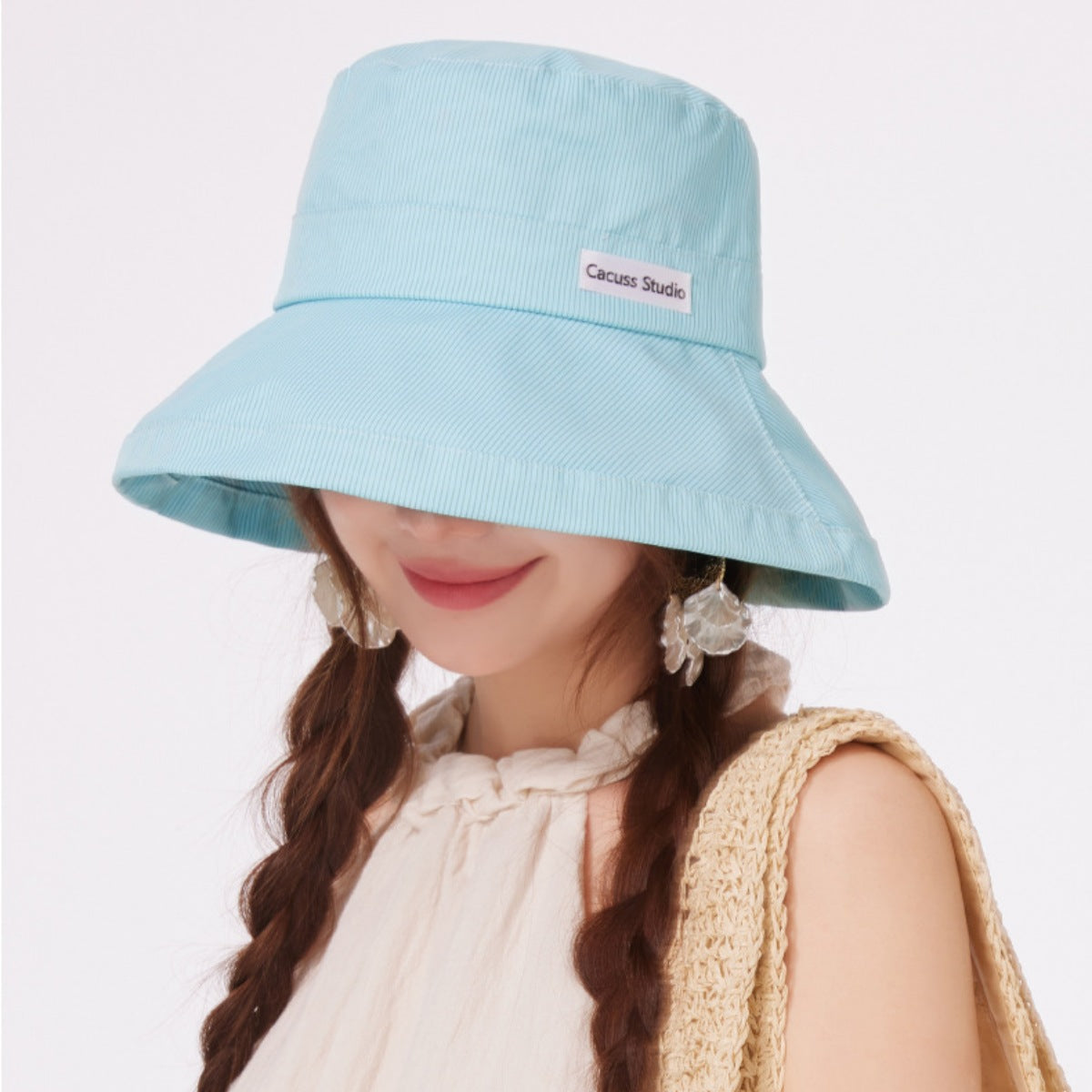 Premium wide brim bucket hat in mint green with subtle pinstripe texture and a wide, floppy brim.