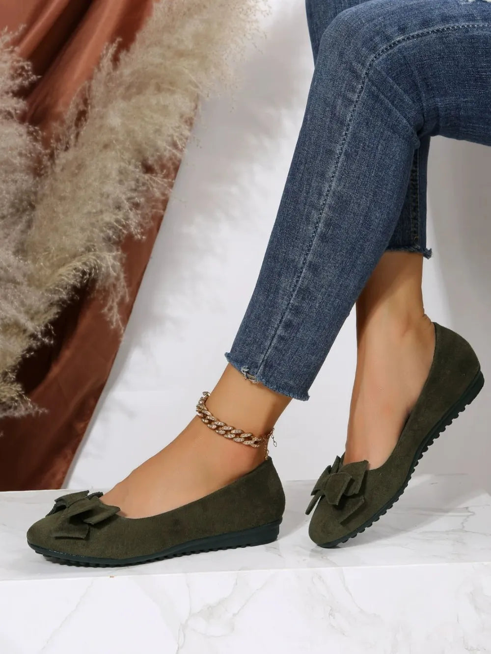 Moss suede pointed-toe flats with bow embellishment and ankle chain detail