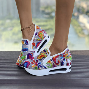 Vibrant slip-on platform sneakers with colorful paisley embroidery and white soles.