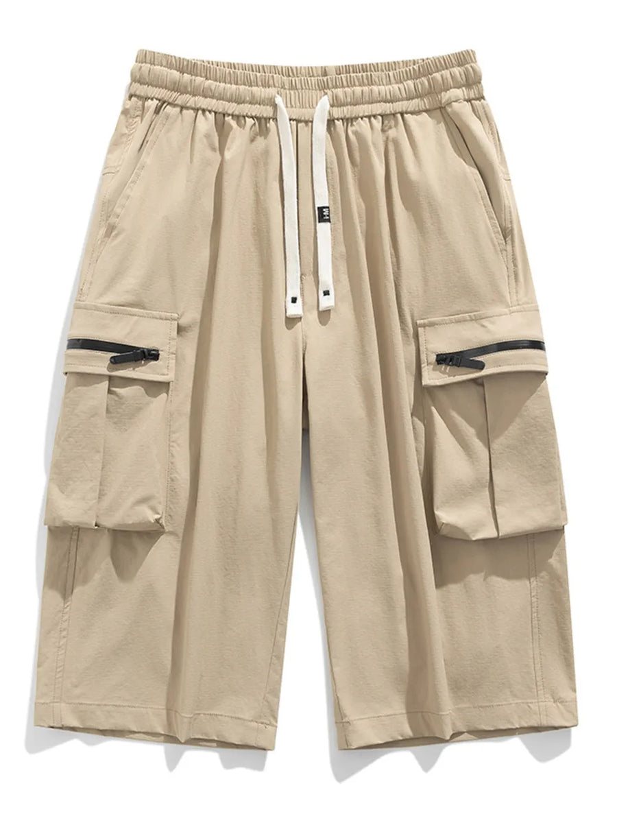 Khaki cargo shorts with elastic waist, drawstring, and zippered pockets.