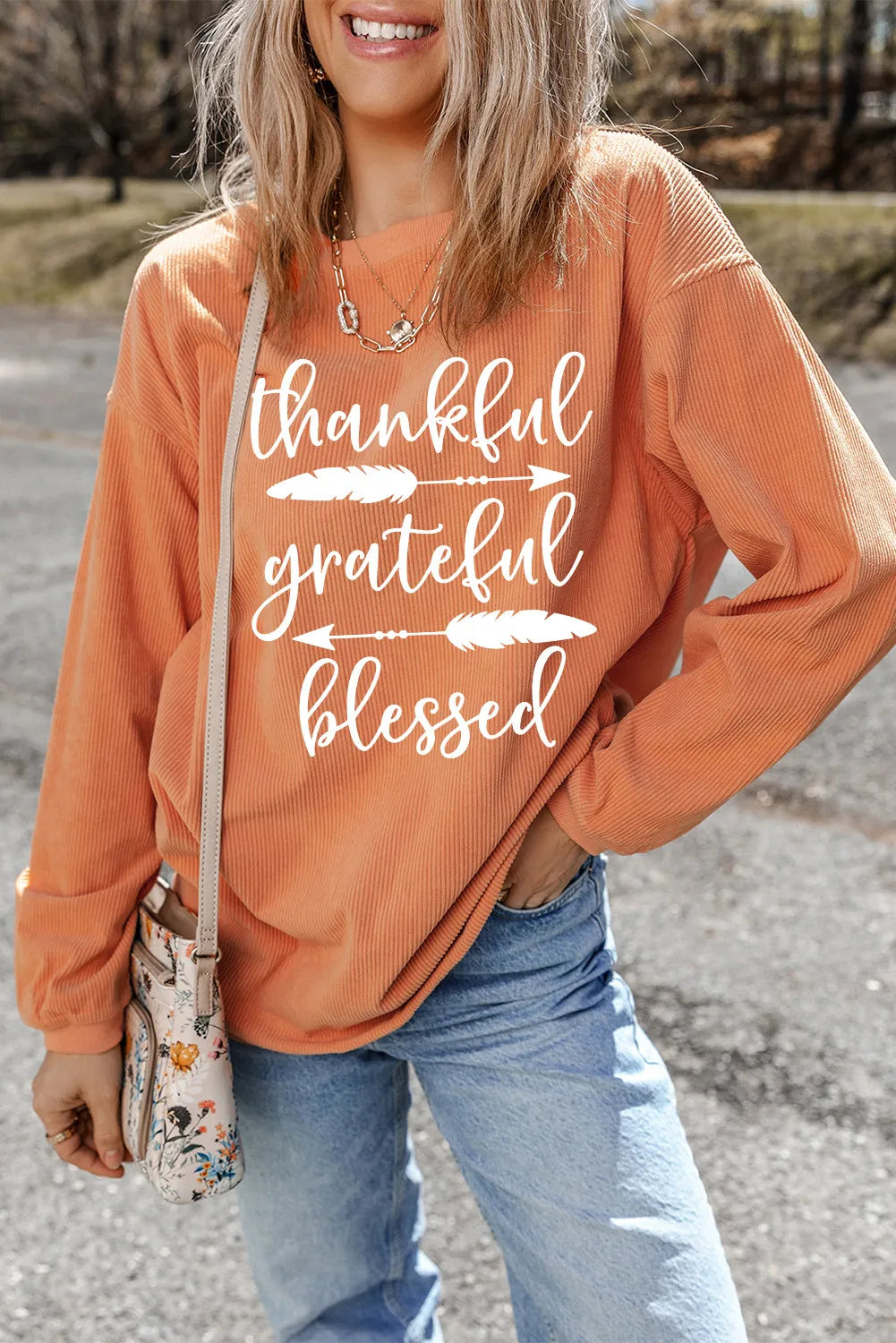 Corduroy graphic crewneck sweatshirt in sherbet with white text that says thankful grateful blessed.