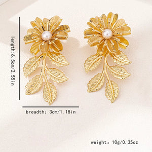 Golden floral drop earrings with pearl center and leaf accents, 18K gold-plated.