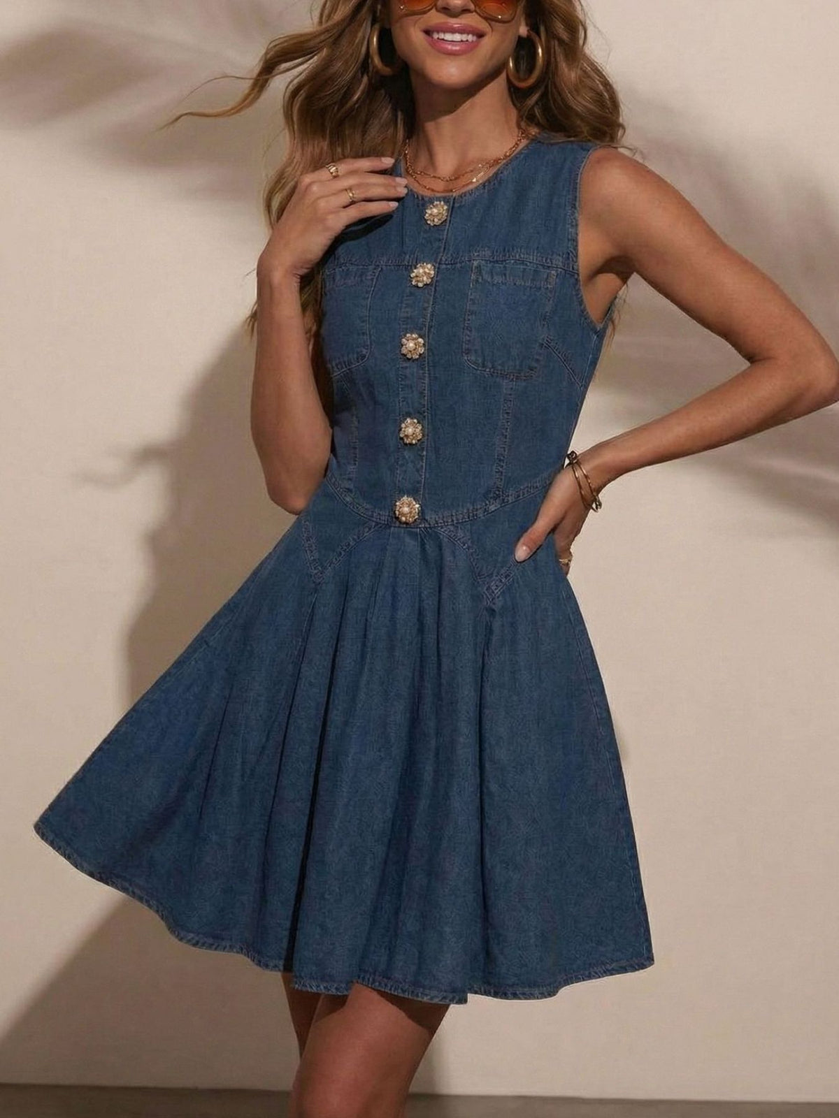 Denim A-line dress with decorative buttons, sleeveless, and a flared skirt.