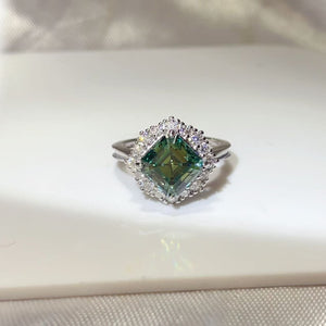 ring in emerald green featuring halo setting and fitted fit