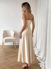 Cream V-neck maxi dress with spaghetti straps, a-line cut, and a lustrous finish.