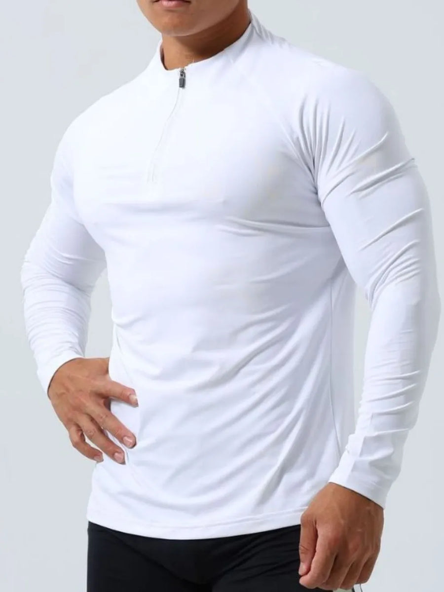 White performance raglan zip-neck active top with long sleeves.