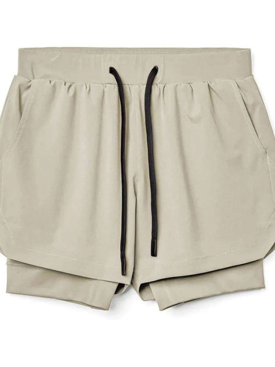 Khaki layered performance shorts with black drawstring and perforated panels.