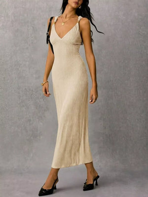 Ivory ribbed midi dress with crisscross straps and a V-neck.