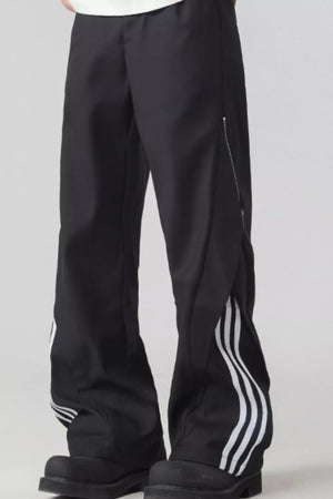 Black wide-leg sweatpants with white side stripes and a zipper detail.
