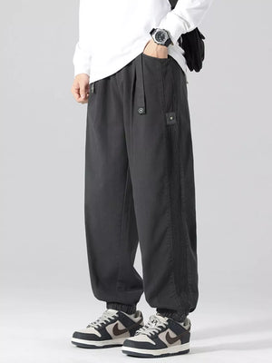 Oversized grey cargo joggers with drawstring and ribbed side detail.