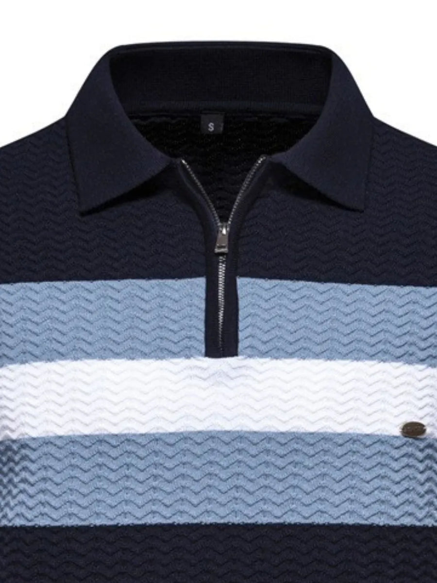 Chevron stripe zip polo in dark navy, light blue, and white with textured fabric.