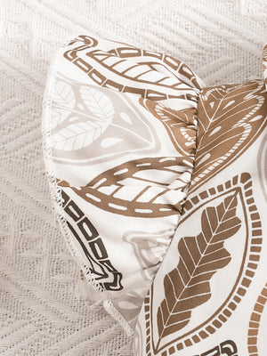 Baby girl's beige leaf print top with ruffled sleeves and bow detail.