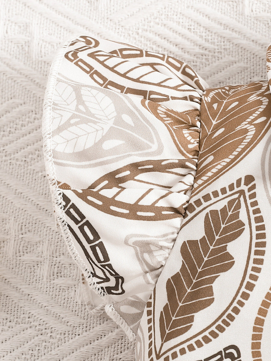 Baby girl's beige leaf print top with ruffled sleeves and bow detail.