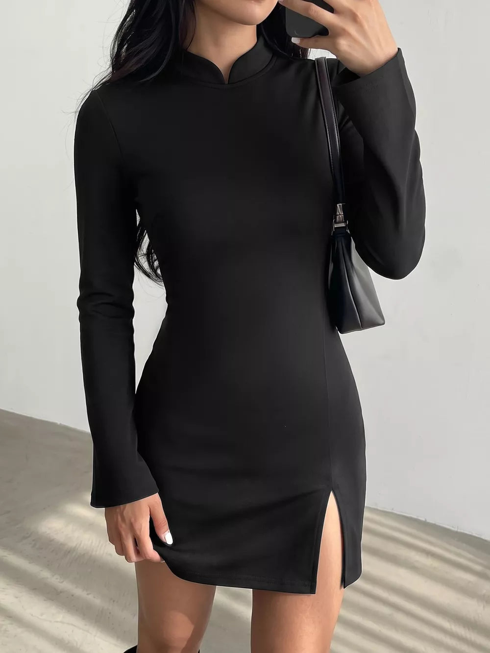 mini dress in black featuring slit and bodycon fit