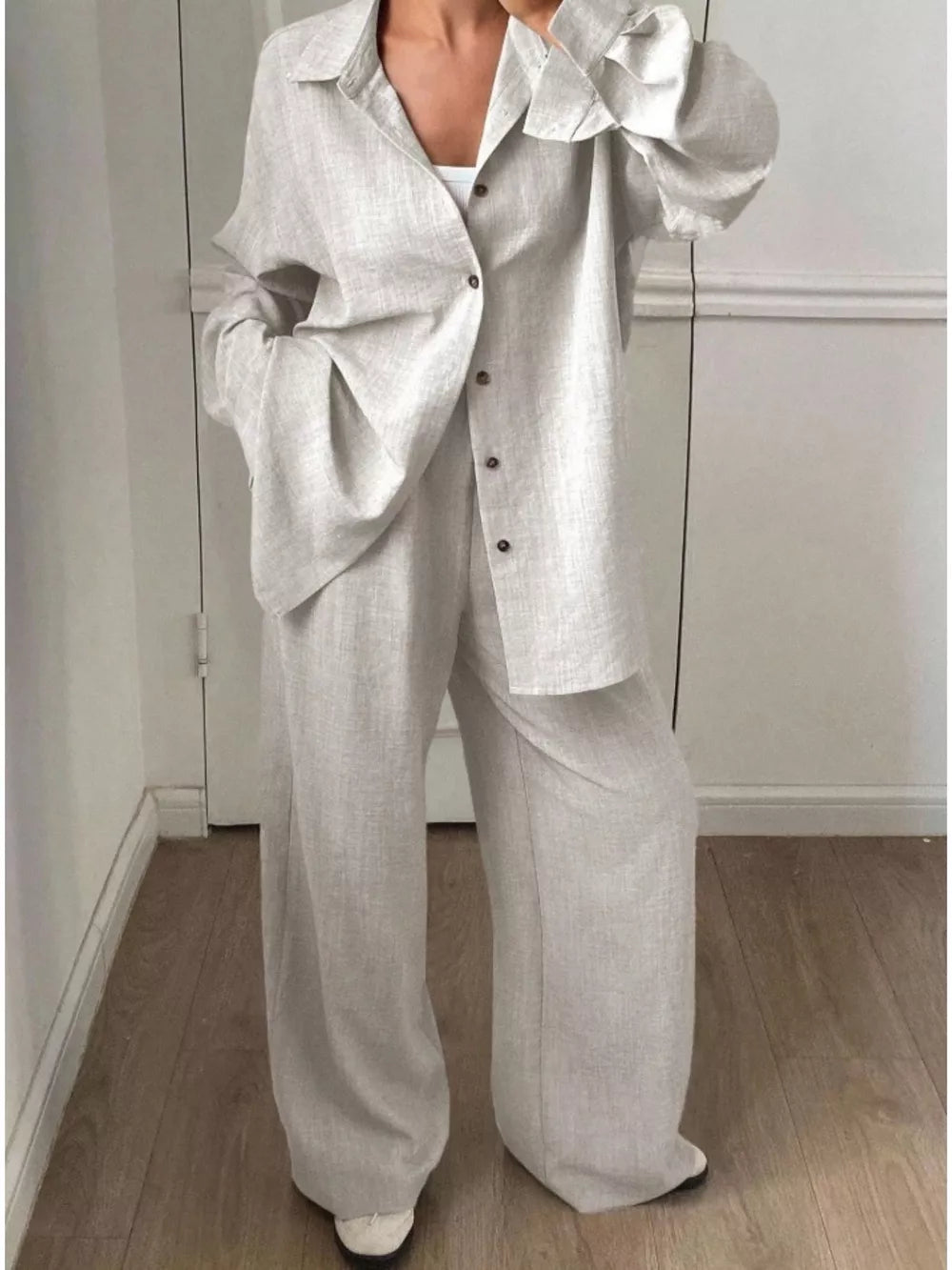 two-piece set in light beige featuring collared and relaxed fit