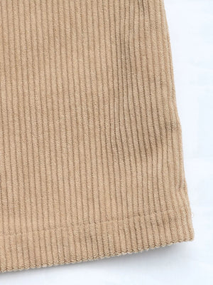 Tan corduroy overall dress detail showing vertical wales and hem