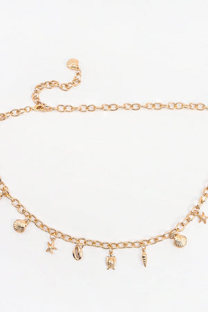 Gold chain belt with shell, starfish, turtle, and cone charms.