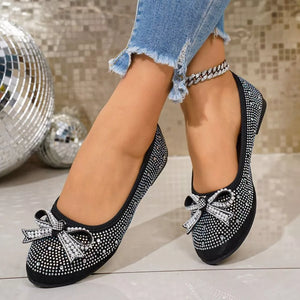 Black rhinestone-embellished bow flats with a crystal anklet.