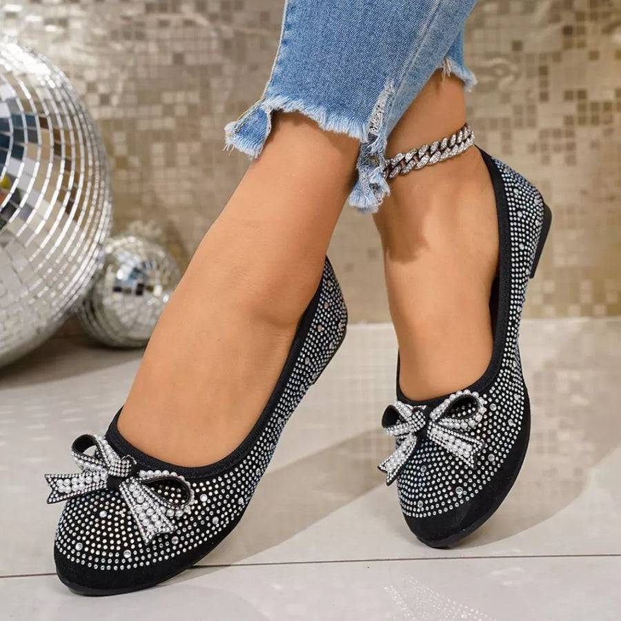 Black rhinestone-embellished bow flats with a crystal anklet.