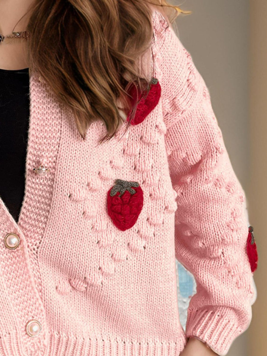 Pink knit cardigan with strawberry patchwork detail and pearl buttons