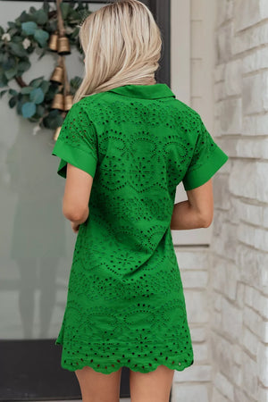 Green eyelet collared dress with scalloped hem and short sleeves.