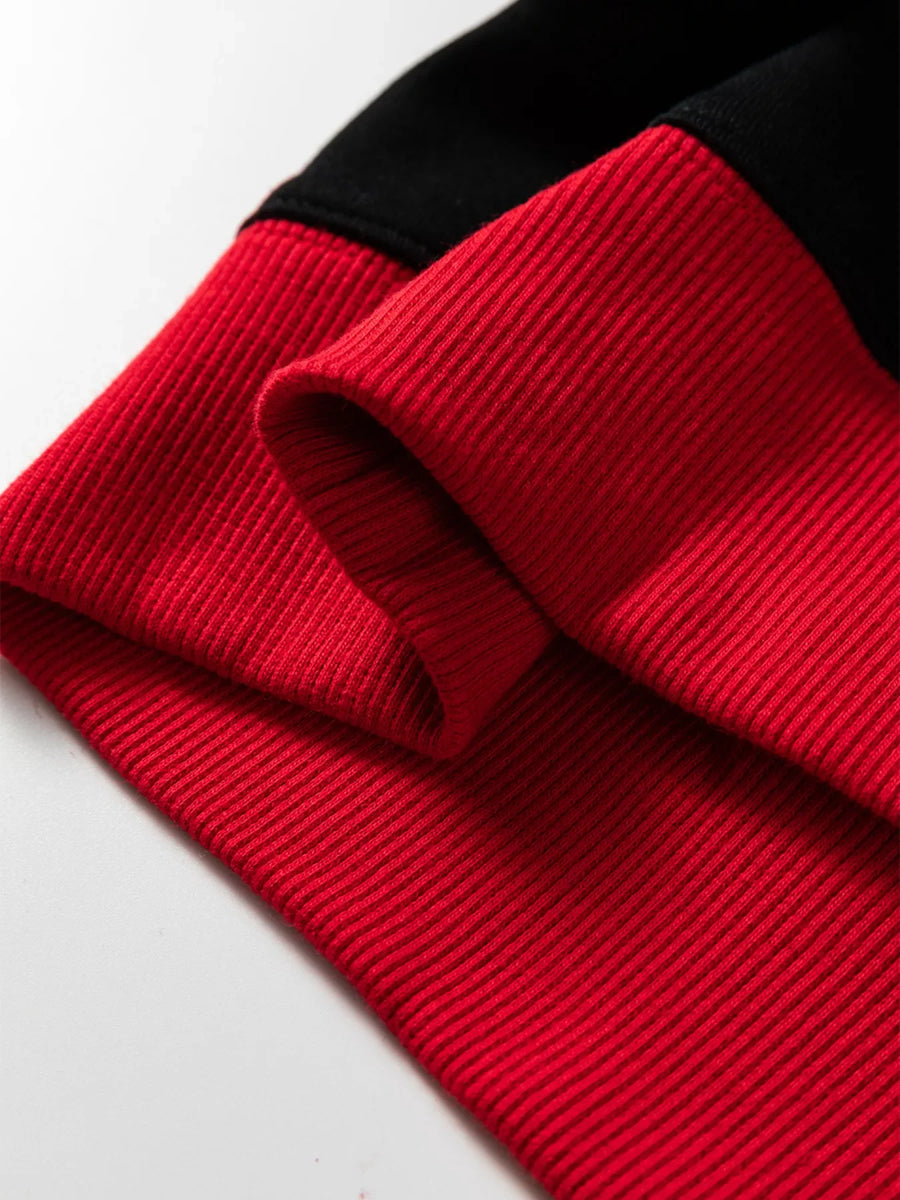 Black and red varsity style sweatshirt detail showing ribbed cuffs and hem