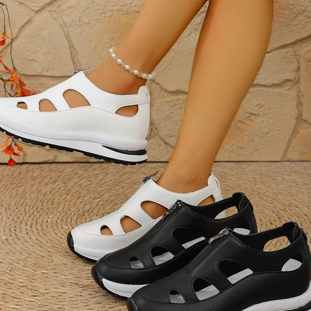 Chic cutout wedge sneakers in black and white with zipper detail and chunky sole.