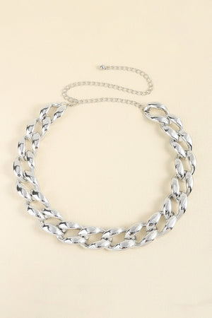 Silver sculptural chain waist belt with adjustable link chain.
