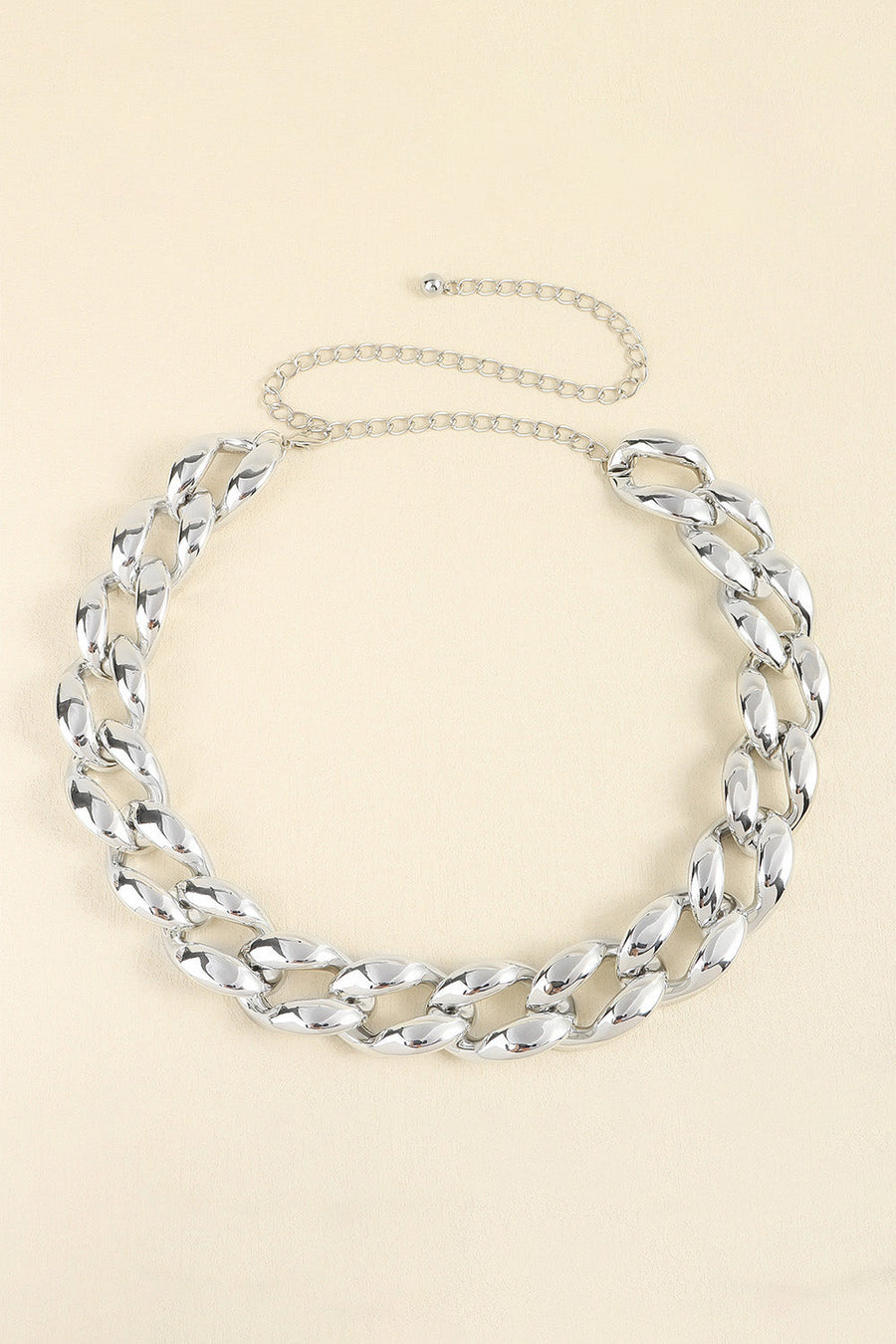 Silver sculptural chain waist belt with adjustable link chain.