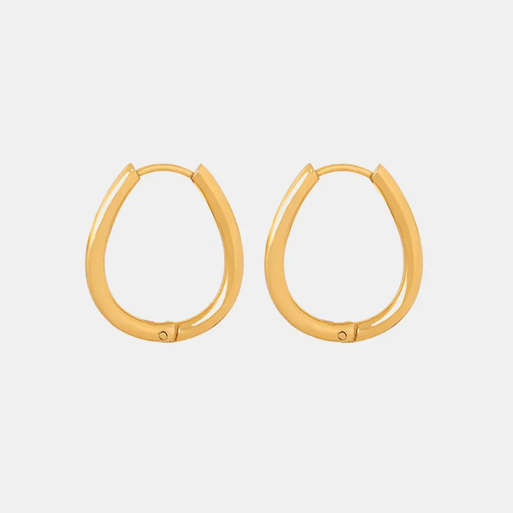 Gold oval hoop earrings with pearl drop detail