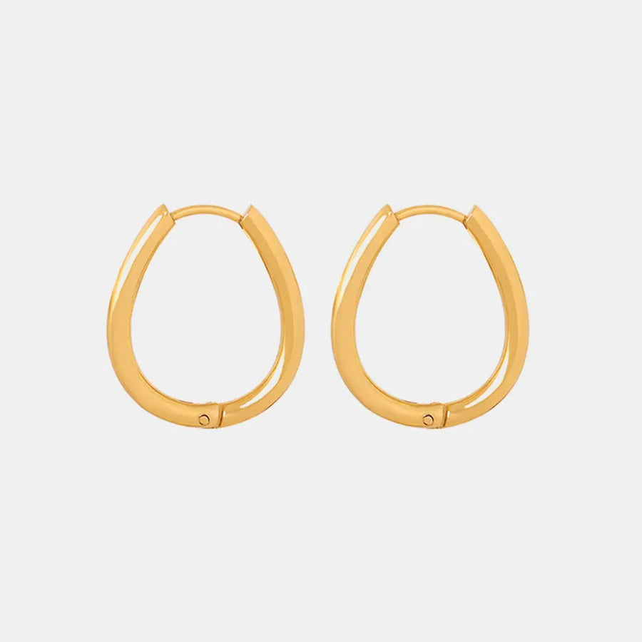 Gold oval hoop earrings with pearl drop detail