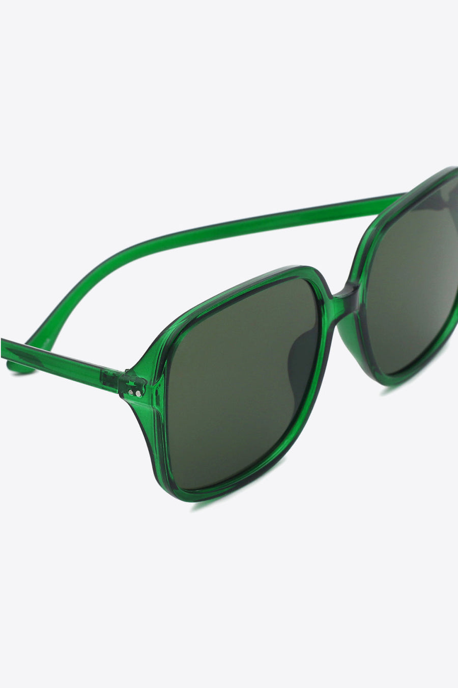 Green retro square frame sunglasses with dark lenses and bold acetate frames.