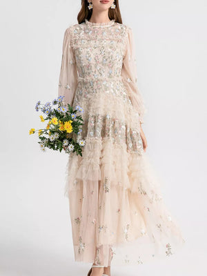 Embroidered floral tulle maxi gown with ruffled tiers and long sleeves.