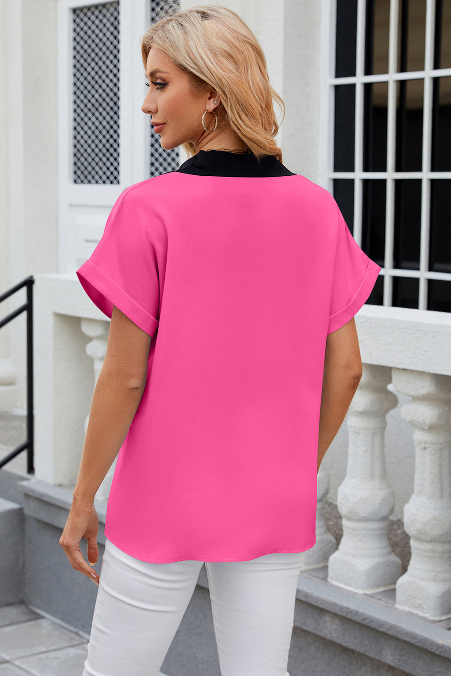 Hot Pink blouson top with black contrast V-neck and cuffed short sleeves.