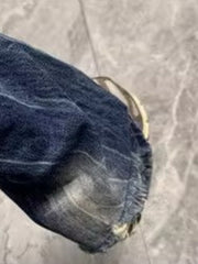 Men's distressed blue denim jeans with a baggy fit and pocket detail.