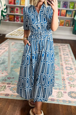 Midi shirt dress in blue and white geometric print with drawstring waist and pockets.