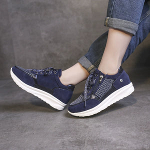 Blue rhinestone embellished lace-up sneakers with a chunky white sole.