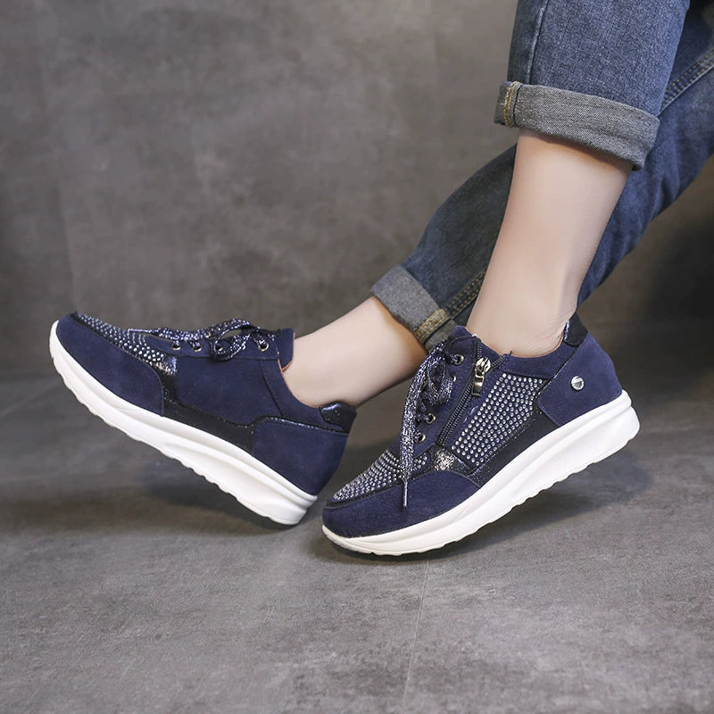 Blue rhinestone embellished lace-up sneakers with a chunky white sole.