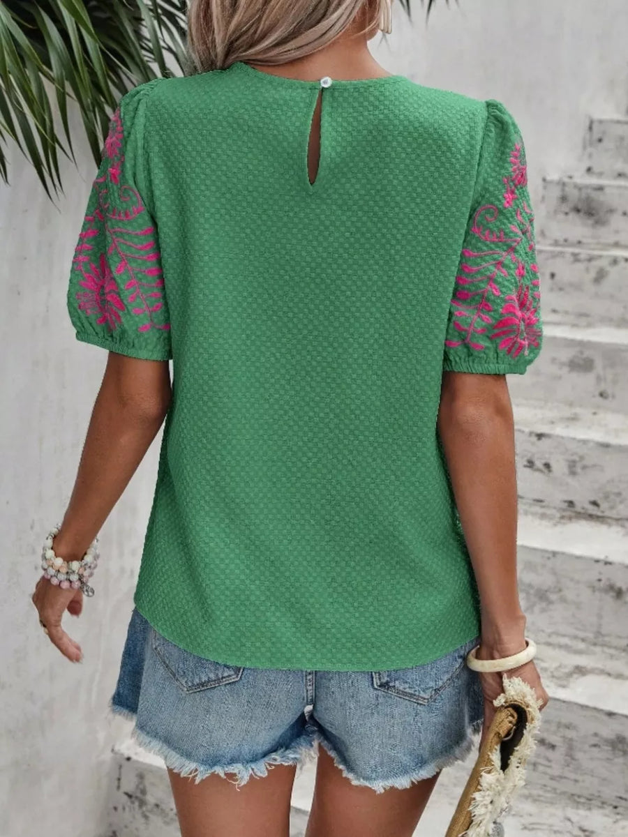 Green embroidered puff sleeve blouse with textured fabric and keyhole back.