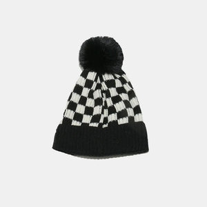 Checkerboard knit beanie with black faux fur pom.