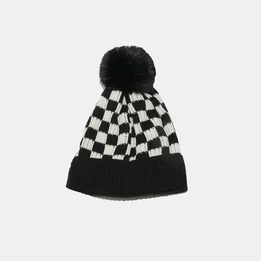 Checkerboard knit beanie with black faux fur pom.