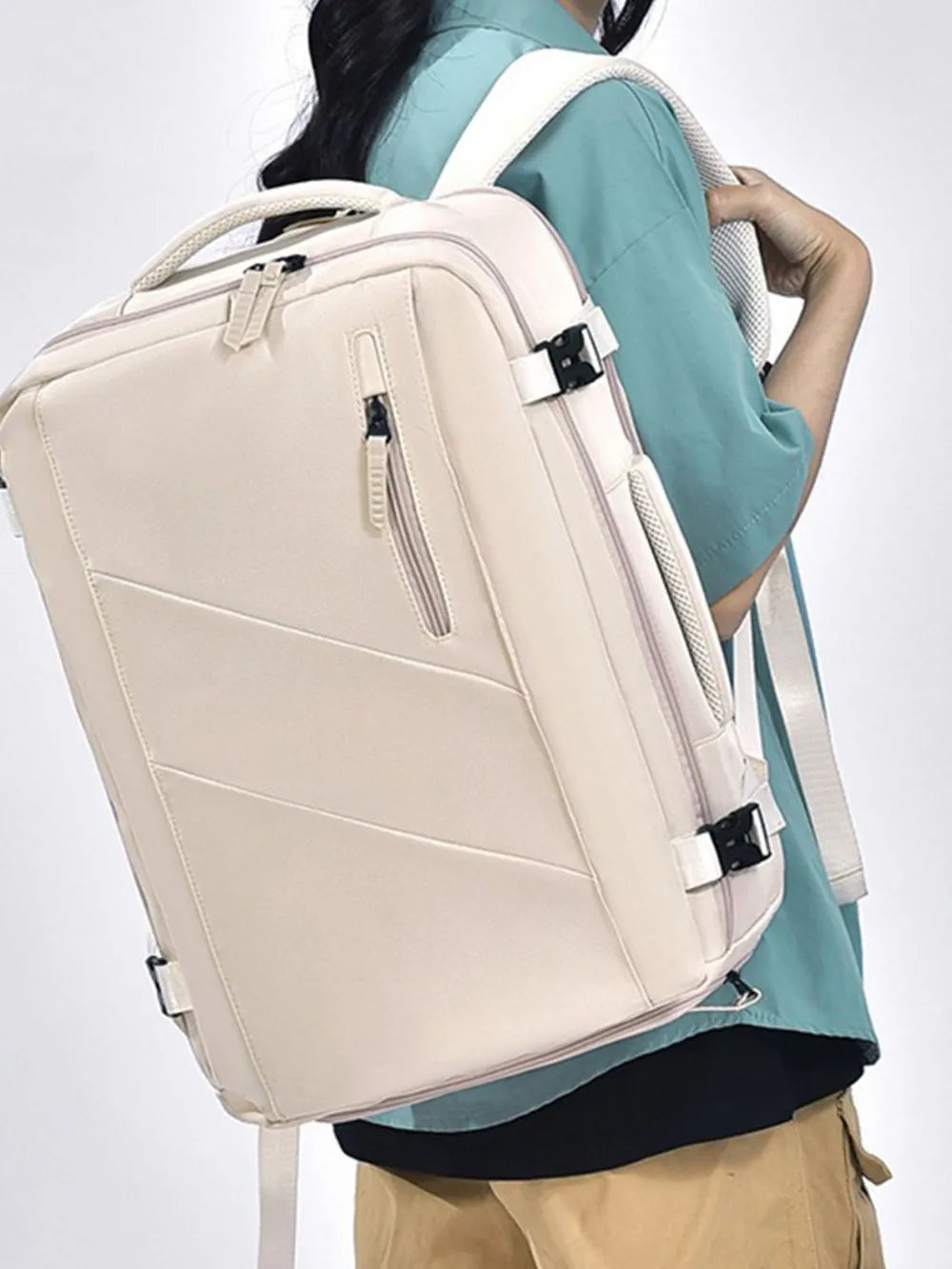 Beige structured backpack with shoe compartment and adjustable straps.