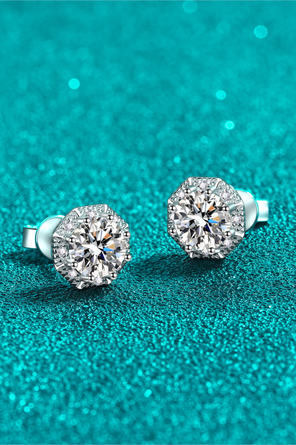 Octagonal halo moissanite stud earrings in silver with sparkling accents.
