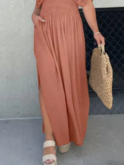 Apricot V-neck maxi dress with smocked waist, dolman sleeves, and side slits.