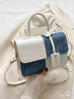 Chic two-tone PU leather crossbody bag in white and blue denim with top handle and strap.