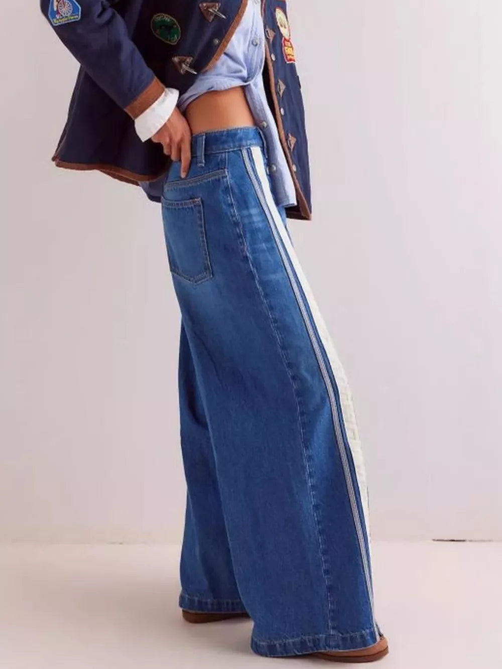 cream wide-leg jeans featuring side snaps and striped